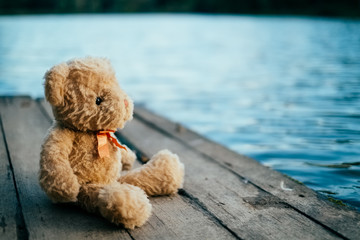 Teddy bear sitting on pier