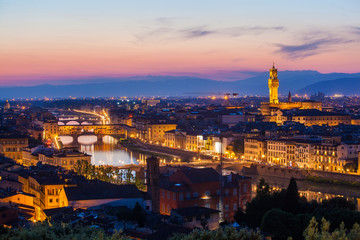 Fototapeta na wymiar View of the river embankment of Arno and cathedrals of Florence from Michelangelo's hill on a sunset