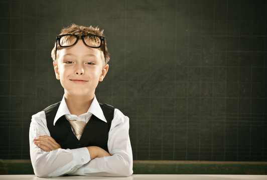 young nerd student with glasses and blackboard