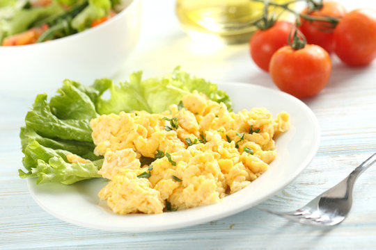 Scrambled eggs with vegetables on a blue wooden table