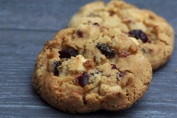 White chocolate and cranberries on rustic wooden table
