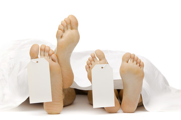 dead body feet with card autopsy isolated on white