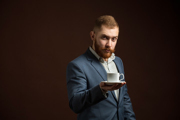 Elegant bearded man with cup of coffee
