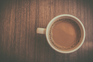 Coffee cup on wood table,top view.