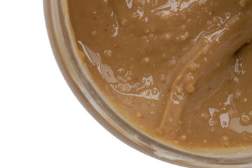 creamy peanut butter spread on jar close up