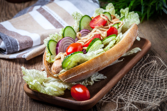 Homemade sandwich on a wooden table.