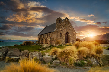 Beautiful sunrise at church of the good shepherd< Lake Takapo, New Zealand - obrazy, fototapety, plakaty