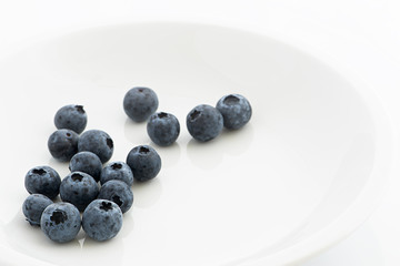 Fresh blueberries on a white plate