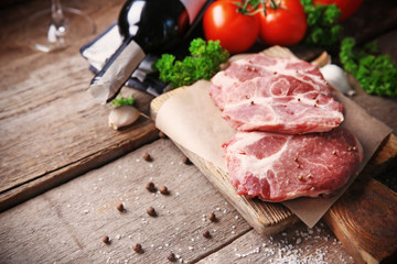 Marbled beef steak and spices on wooden background