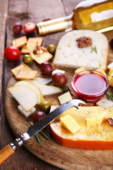 Different kinds of cheese on wooden background