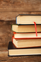 Pile of books on wooden background