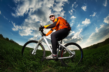 Fototapeta na wymiar Cyclist with the Bike on meadow