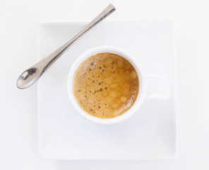 Top view of a cup of coffee on white plate