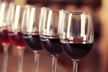 Many glasses of different wine in a row on bar counter