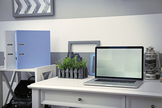 Stylish workplace with laptop at home, closeup