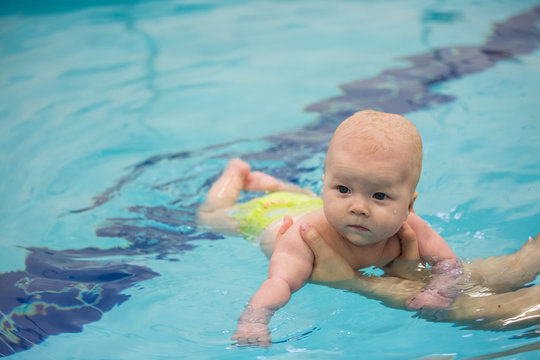 baby girl enjoying her first swim