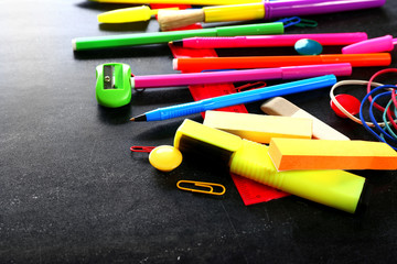 Fototapeta premium Colourful stationery on black background