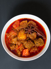 Beef massaman curry, Top view on black background.
