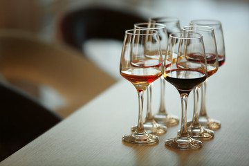 Many glasses of different wine on a table