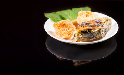 Plate of Gourmet Poppy Seed Pastries with Mint