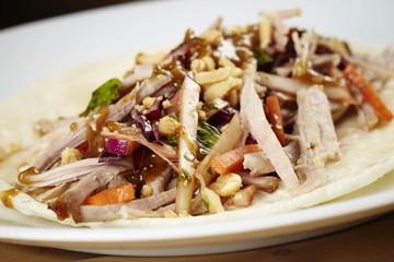 Slowly roasted pork shoulder with salad and tortilla