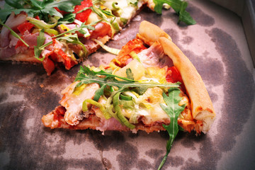 Sliced fresh pizza on cardboard background