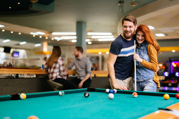 Couple playing billiards