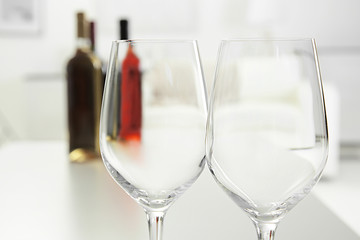 Wineglasses on blurred interior background