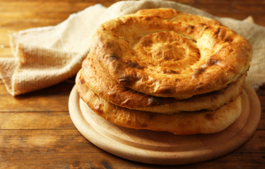 Flat bread on wooden mat on table