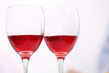 Dinner with glasses of wine on light blurred background
