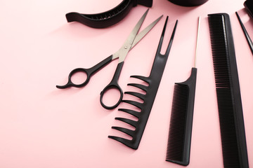 Hairdresser set with various accessories on pink background