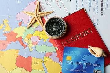 Credit cards with passports and tickets for vacations on the world map background