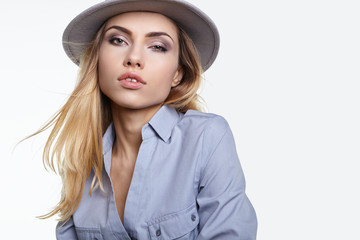 Portrait of a sensual girl in a stylish gray hat isolated