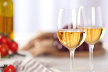 Glasses of red wine with food on table closeup