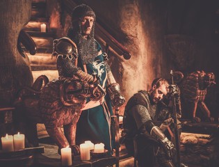 Medieval knights in ancient castle interior.