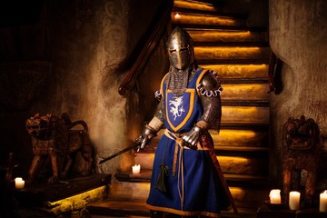 Medieval knight on guard in ancient castle interior.