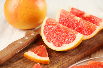 Fototapeta na wymiar Sliced grapefruits with mint on wooden background, close up