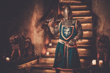 Medieval knight on guard in ancient castle interior.