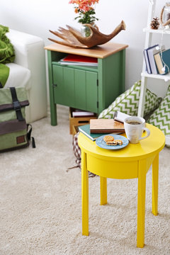 Interior of living room with yellow table
