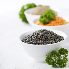 Bowls of assorted dried lentils with red lentils, black beluga l