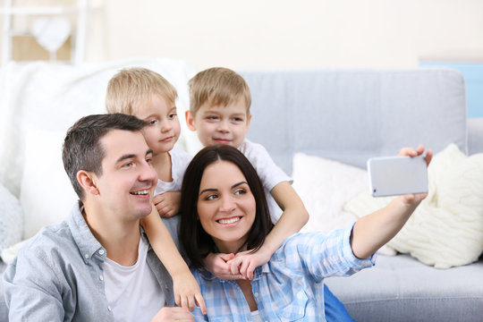 Happy family making selfie on couch background