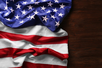 Fototapeta premium Flag of United States of America on wooden table closeup