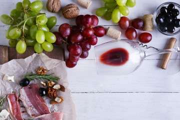 Wine, snacks and different various of cheese, flat lay