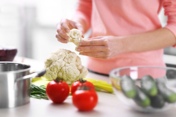 Woman chopping vegetables in kitchen