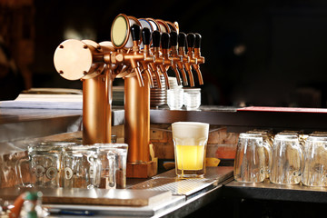 Draught beer taps in a bar.