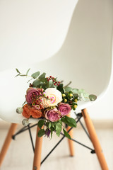 Bouquet of roses on a white chair, closeup