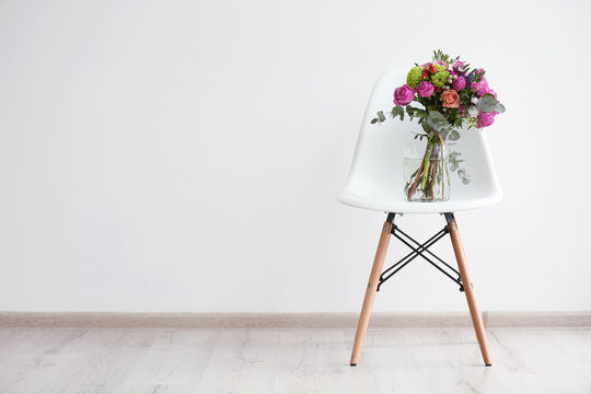 Bouquet Of Roses On A White Chair In Room