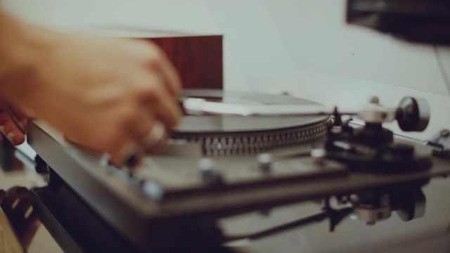 Man plays a record on his turntable