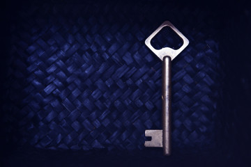 Old key on blue wicker background