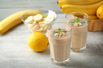 Fresh banana cocktail with peanuts on grey background